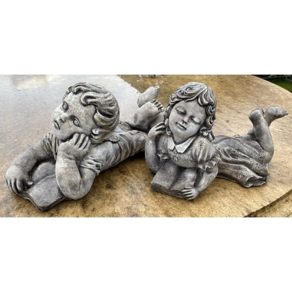 Girl and Boy Lying with Book Small Concrete Statue Pair